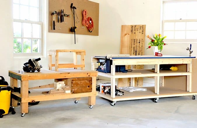 DIY Mobile Workbench and Home Workshop Reveal Garage corner with mobile workbench and side workbench with table saw and peg board with tools.