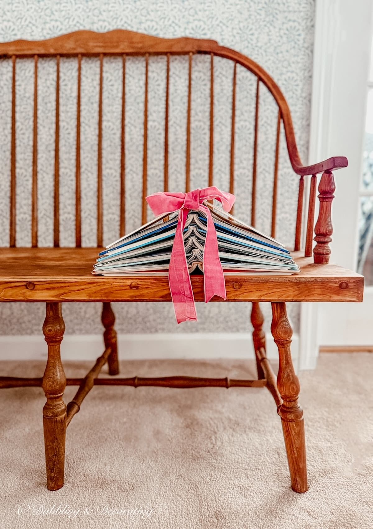 Christmas Book Tree of Knowledge Book Christmas Tree DIY with pink Ribbon on wooden vintage bench in bedroom for the holidays.