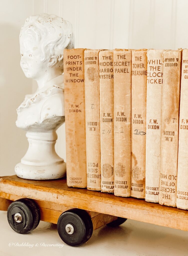 Vintage bust with vintage books on a vintage wooden train