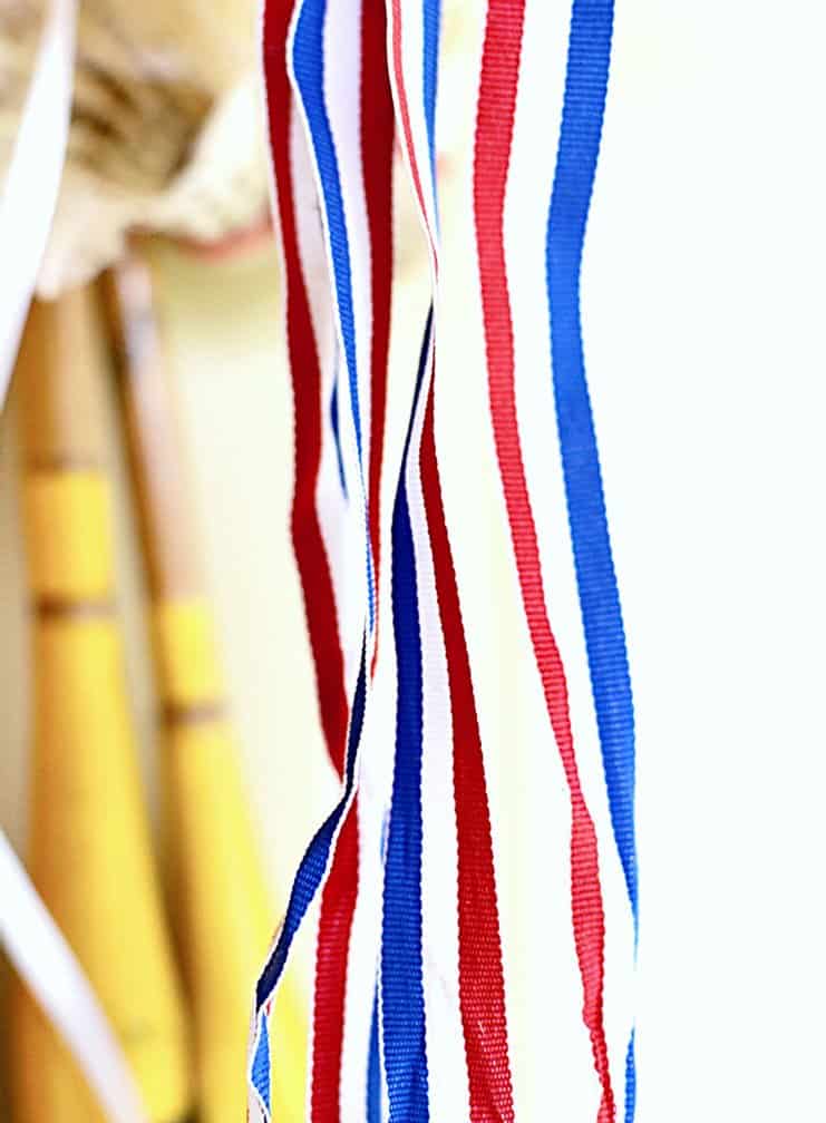 Red, white, and blue ribbon for old badminton racquet wreath
