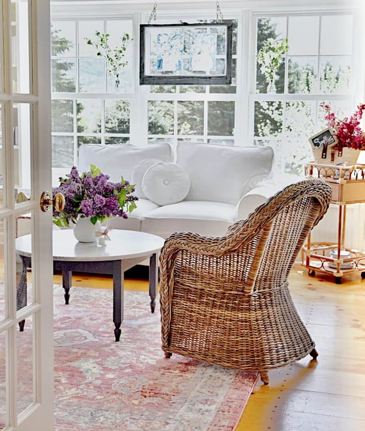 Sunroom Makeover ideas with wicker chairs, white slipcovers and spring details.
