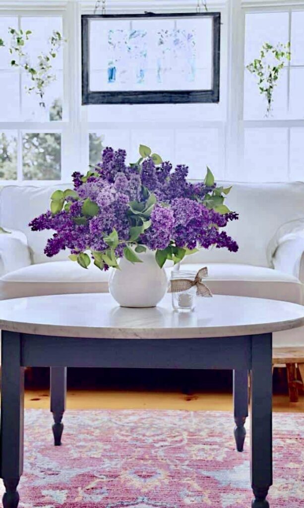 Lilac Arrangement on coffee table in sunroom
