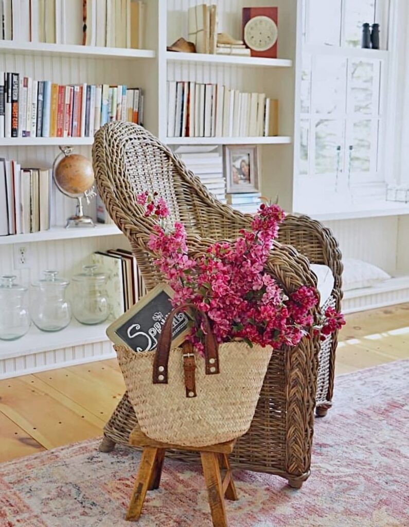 Wicker chair in vintage room style with basket of apple blossoms