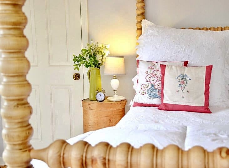 DIY Side Table Using Old Cheese Crates next to Canopy Bed