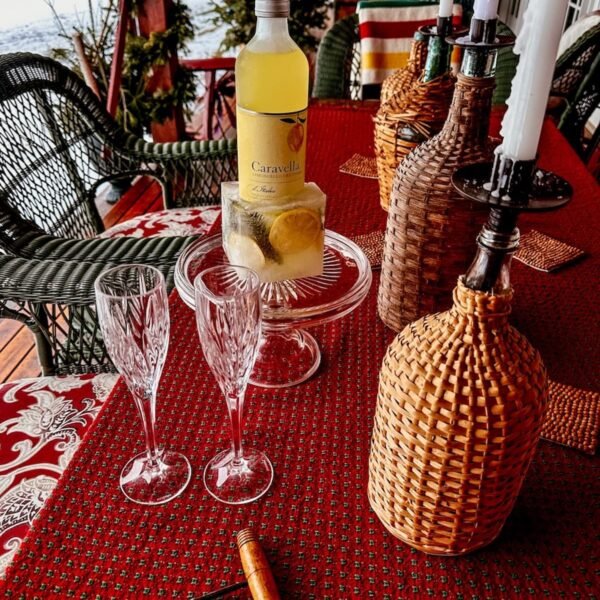Limoncello in DIY frozen ice bucket on Après Ski Themed Table on porch table. Transitioning from Christmas to winter decor.