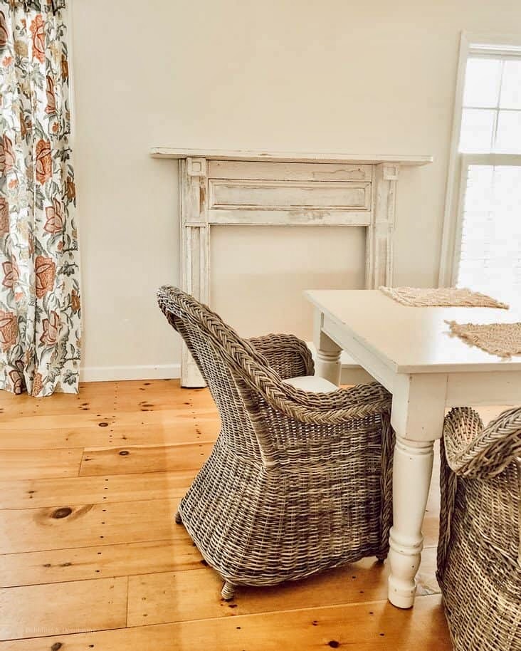 Vintage Faux Fireplace mantel in white leaning up against vintage dining room wall.