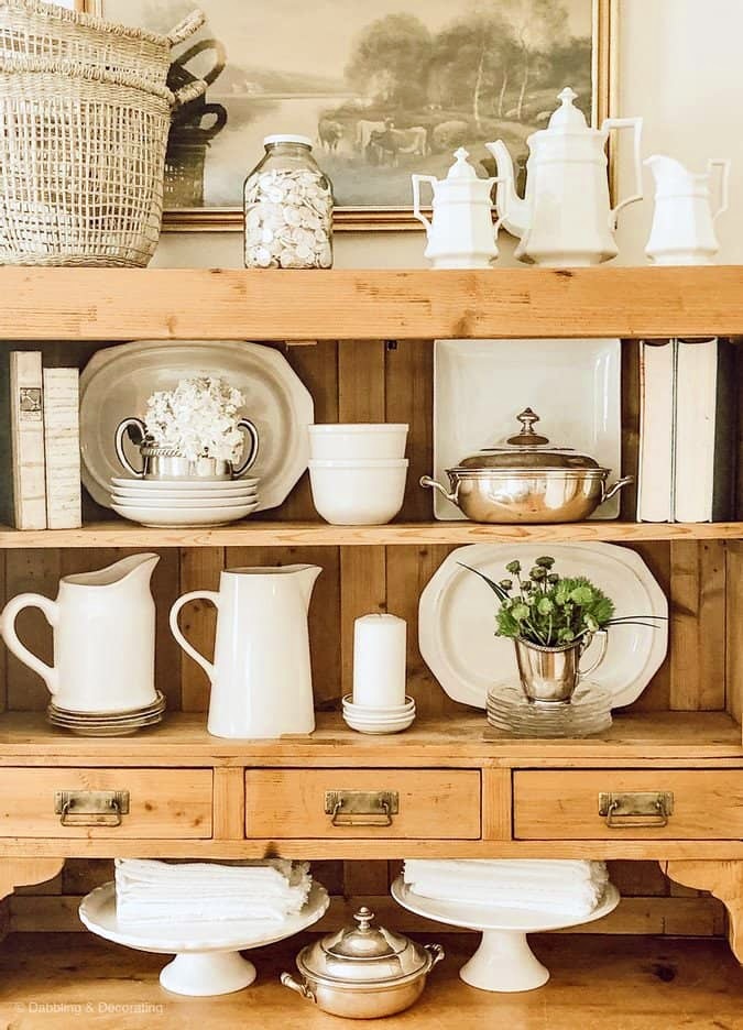 antique  cabinet decorated in white and silver accessories, farmhouse style.