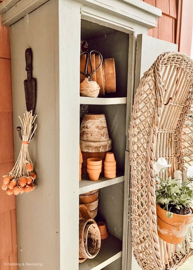 Gardening cupboard with terracotta pots.