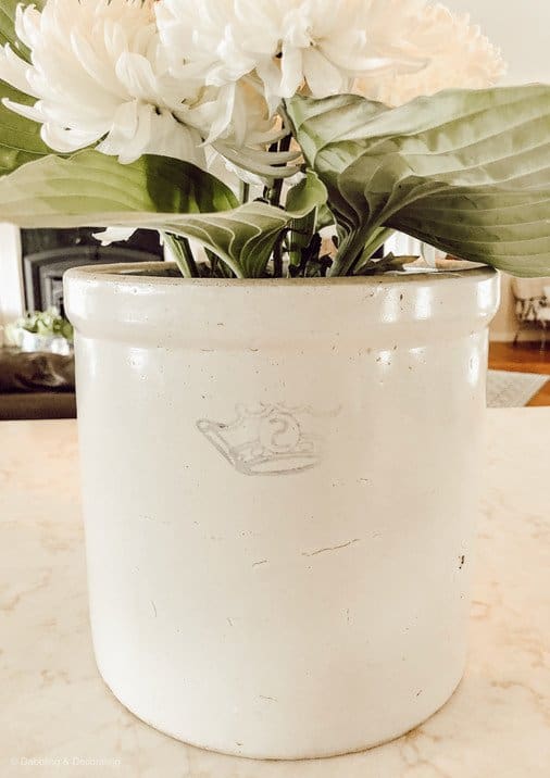 Antique Crockery with Hosta leaves and white carnations.