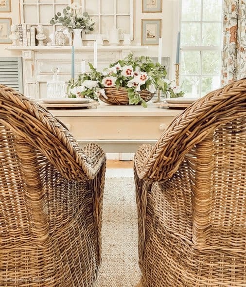 Rose of Sharon Farmhouse Centerpiece in flat basket on white farmhouse table in vintage styled dining room.