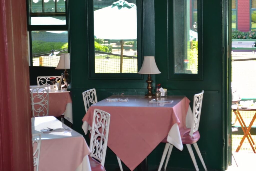 Inside the tennis hall of fame dining room in pink and green in Newport, Rhode Island Tennis Core trend.