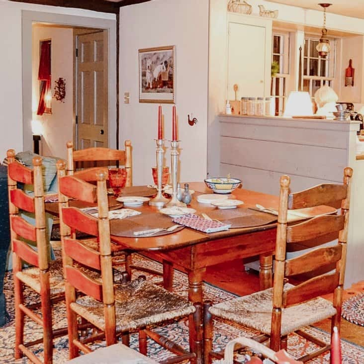 Inside look at dining room with antique style table and chairs inside signature coastal home, Raeside dame home