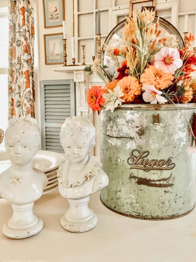 Vintage Sugar tin in green with seasonal flowers for a white farmhouse table centerpiece.