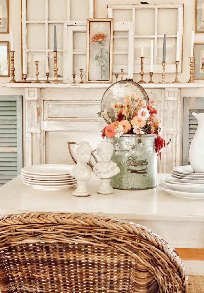 Vintage cottage style white dining room with vintage styled centerpiece with seasonal flowers.