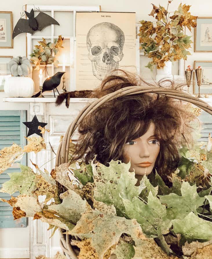 Halloween Vintage Mantel with mannequin head in basket of leaves. Thrifted minks, Science classroom The Skull poster and vintage accents.