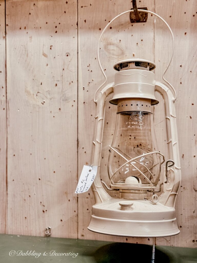 Vintage winter lantern in antique store for winter white antique decor ideas.