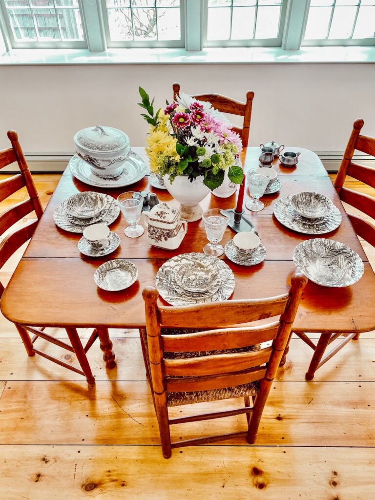 Antique dining room table with brown Royal Mail transferware