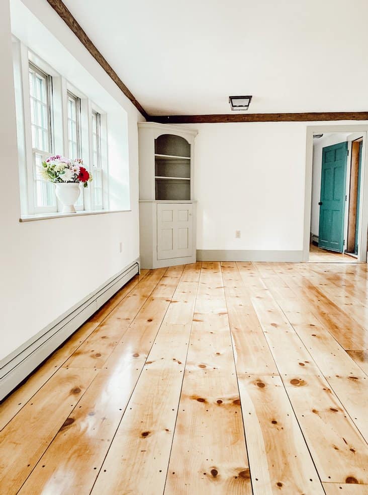 Vintage home renovation dining room with newly refinished pine flooring, Nantucket Gray paint trim and Simply White walls.