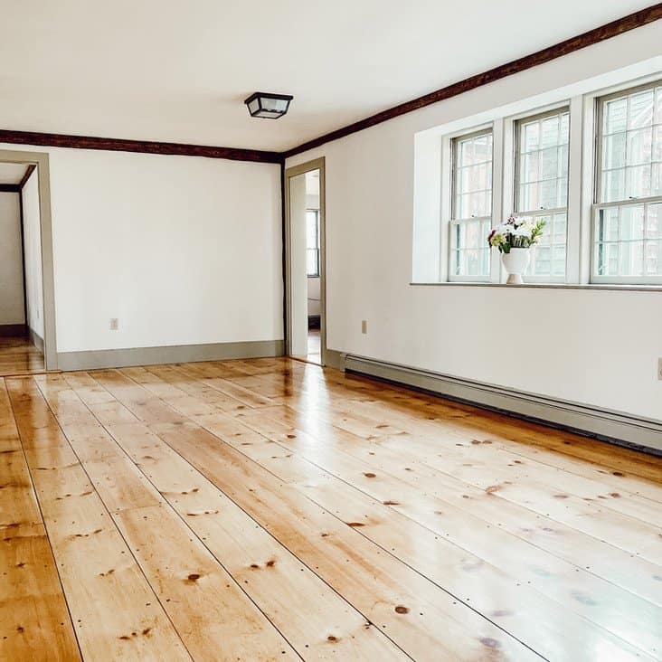 Vintage home renovation dining room with newly refinished pine flooring, Nantucket Gray paint trim and Simply White walls.