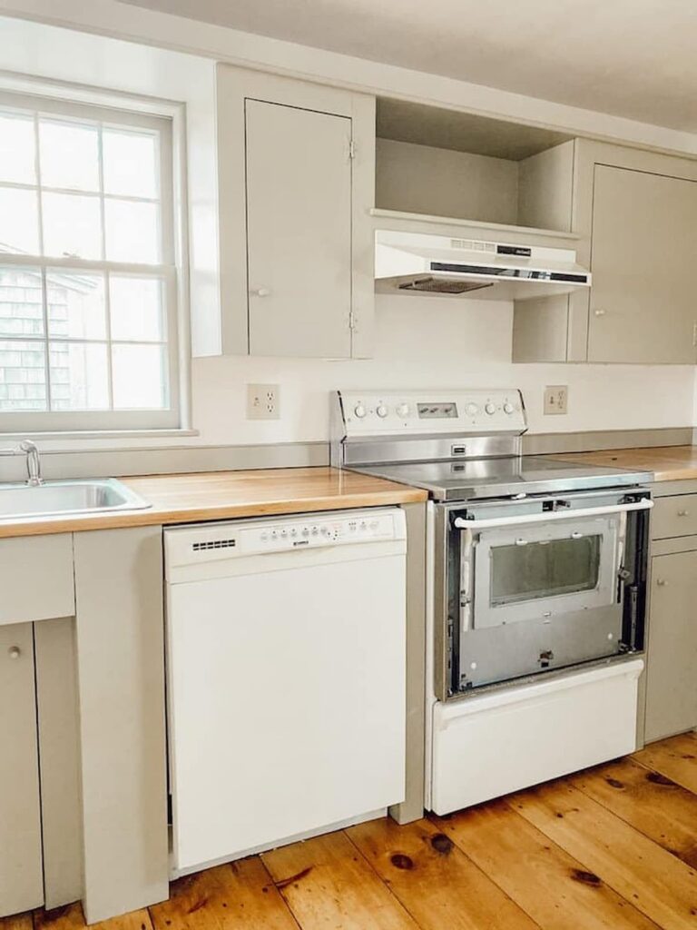 Vintage home restoration in kitchen with newly sanded and refinished wood countertops with Nantucket Gray cupboards and Simply white walls and refinished flooring.