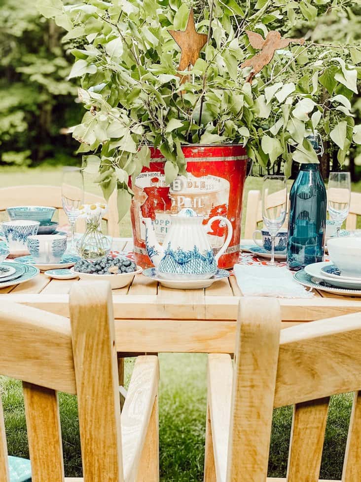 Patriotic tablescape centerpiece with red bucket and greenery