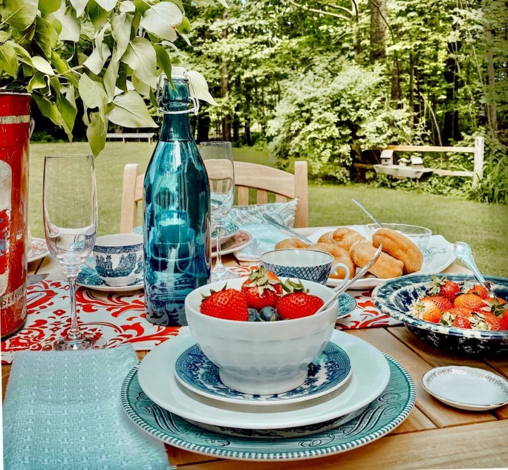 Red, white, and blue place settings on outdoor Patriotic Alfresco table for summer.