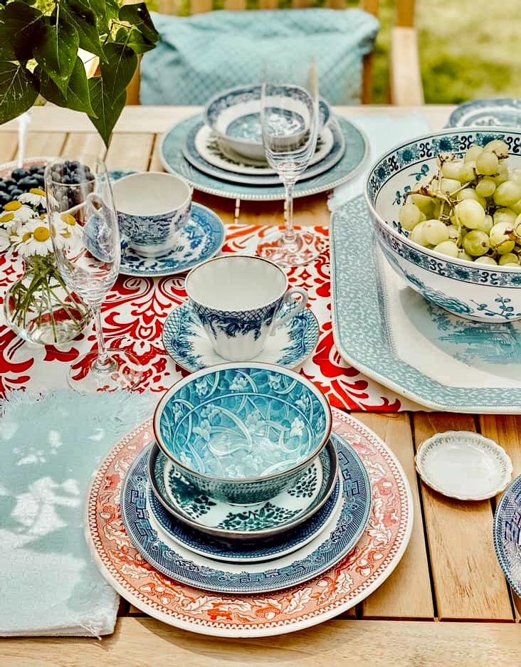 Vintage red, white, and blue dishes on Patriotic alfresco tablescape decor.