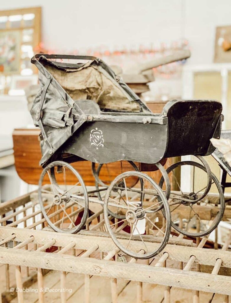 Antique black doll carriage.