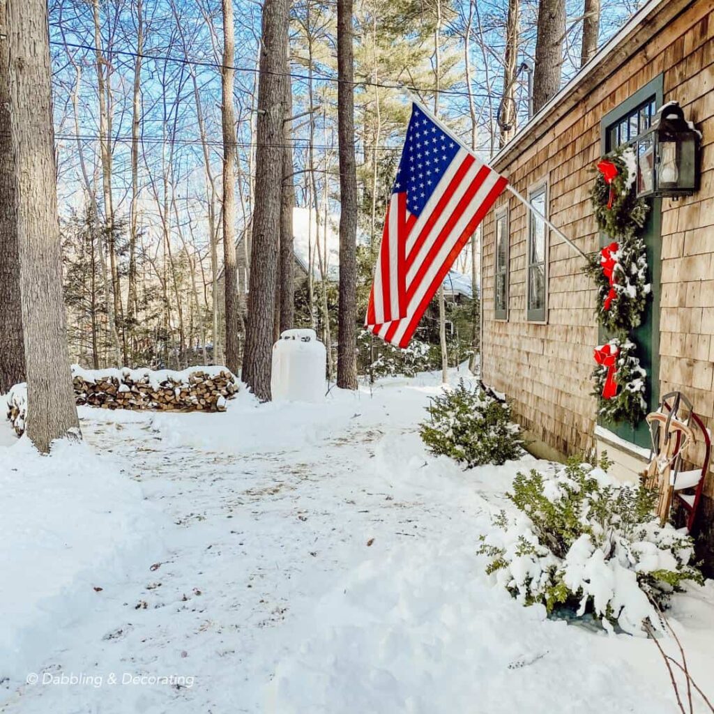 Cottage in Maine Front Door with Christmas wreaths and USA Flag