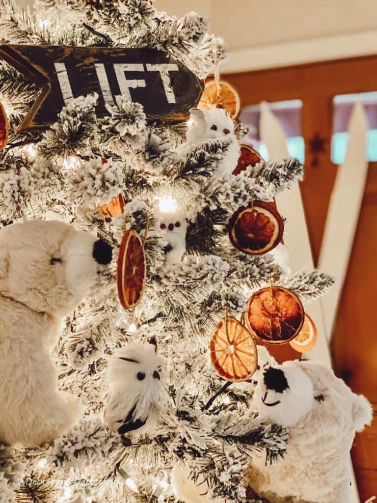 Polar bear Christmas decor ideas on a King of Christmas tree with dried orange slices and owls and vintage ski lodge decor details.