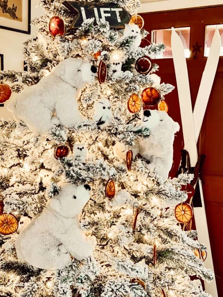 King of Christmas flocked tree with Polar bear Christmas decor, and white owls.