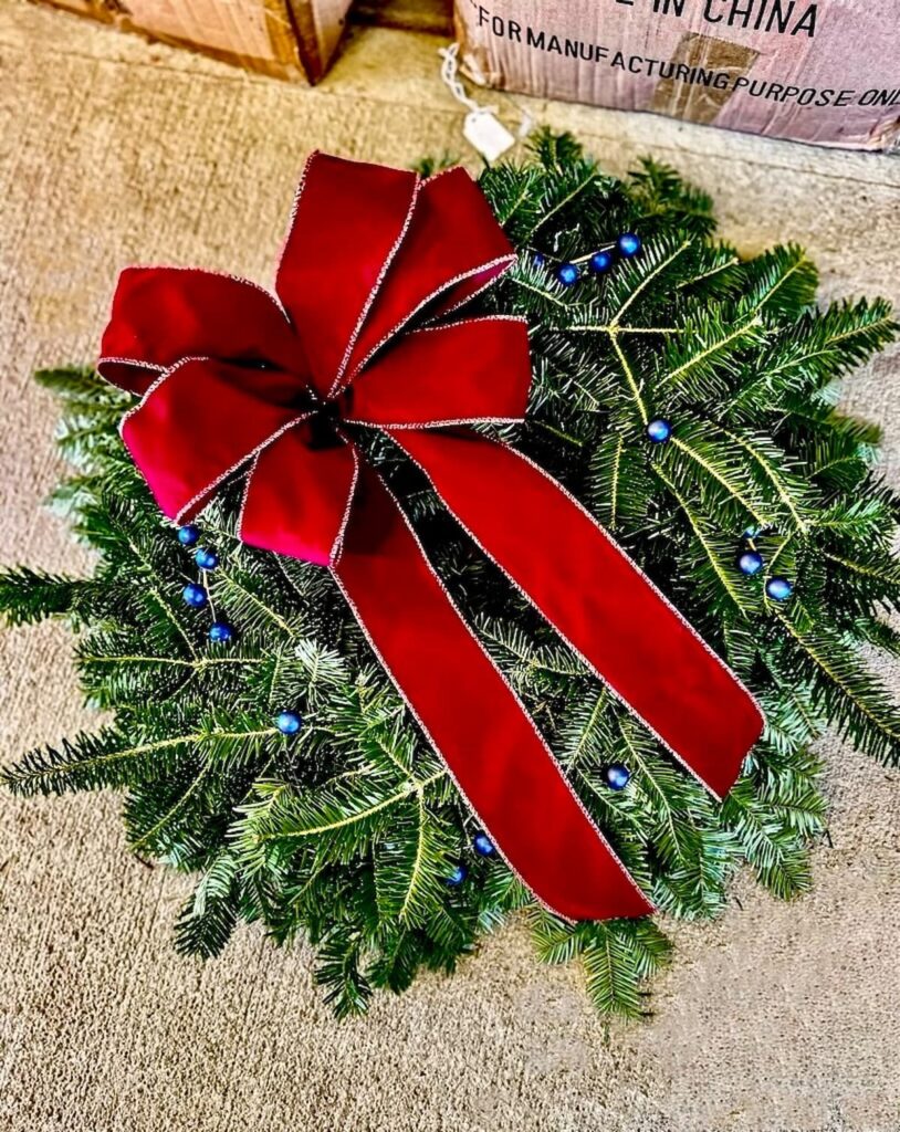 Christmas wreath red bow and blueberry branches.
