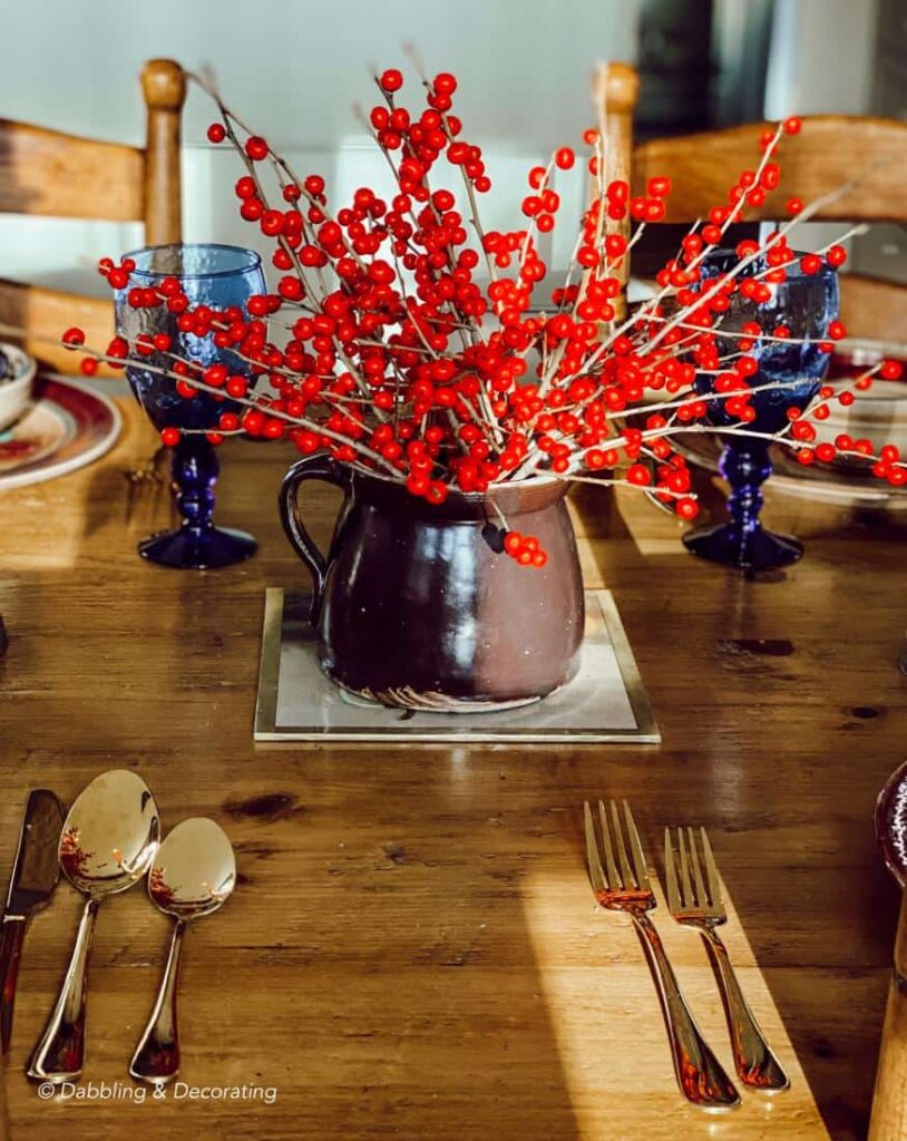 Winterberry tablescape centerpiece in brown vintage jug.