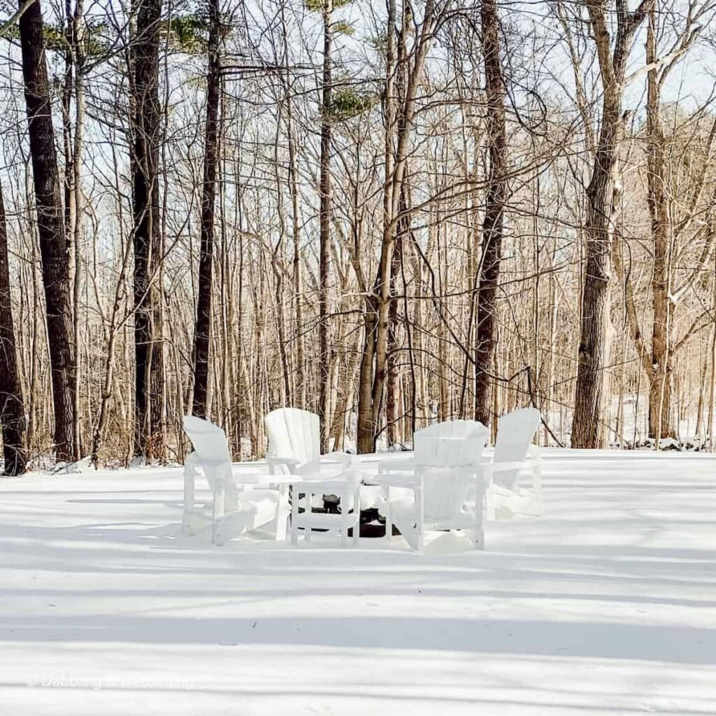 Fire Pit with Adirondack Chairs in the snow.