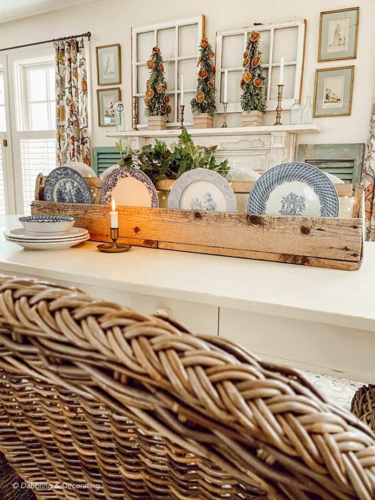 Vintage toolbox with plates on table centerpiece decorated for the holidays.