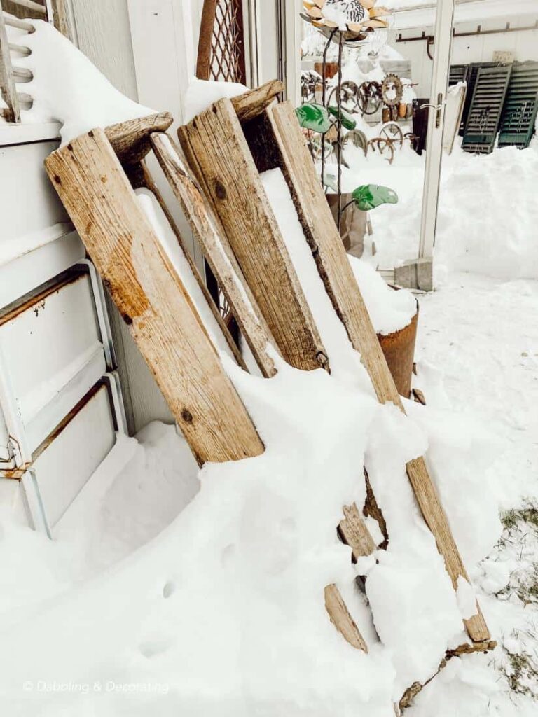 Vintage wooden toolboxes in the snow at second-hand shop.