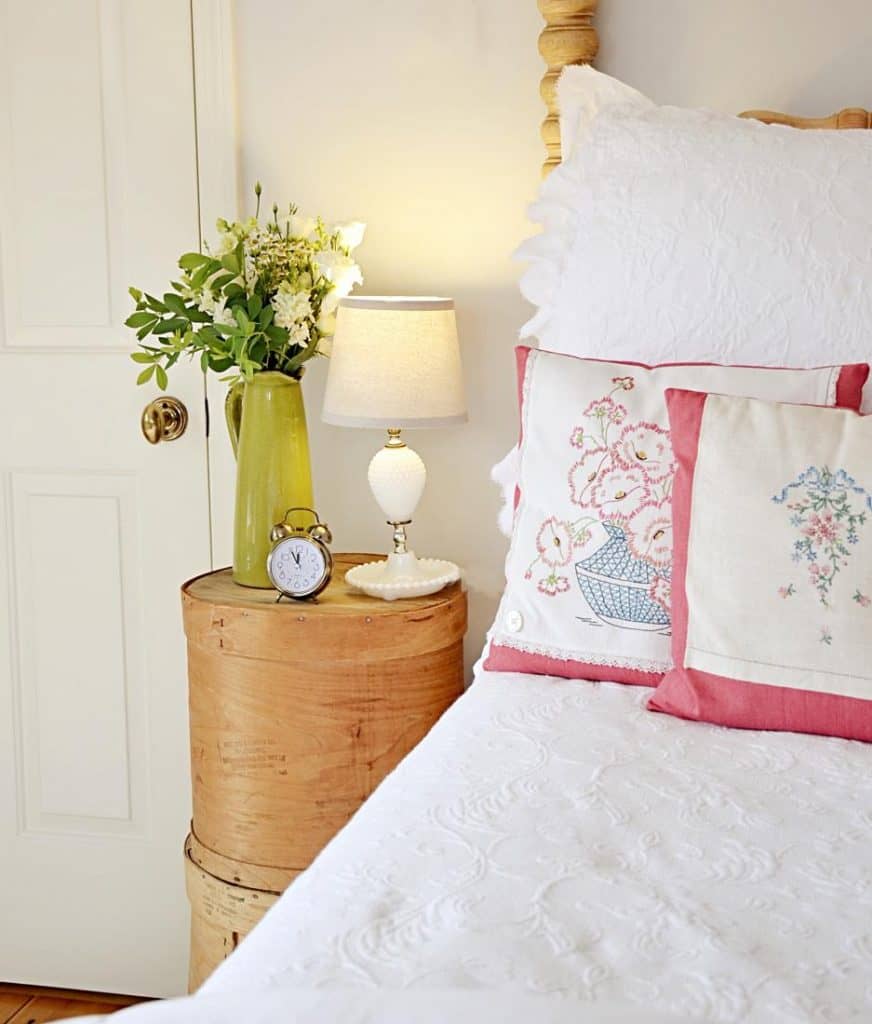 A vintage bed adorned with thrifty pink and white pillows, Vintage Aesthetic Bedroom