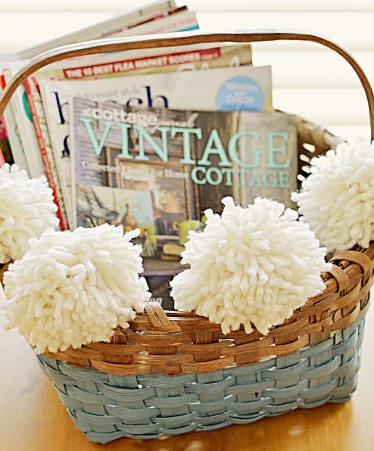 Vintage basket with pom poms and blue paint