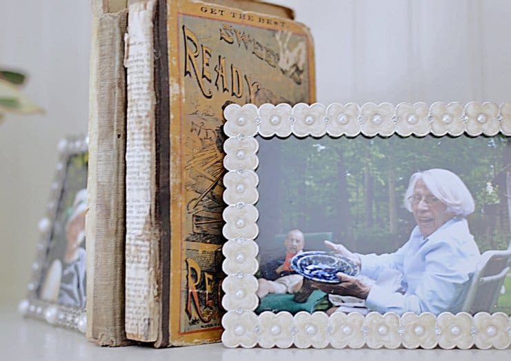 Vintage books with picture frames as bookends.