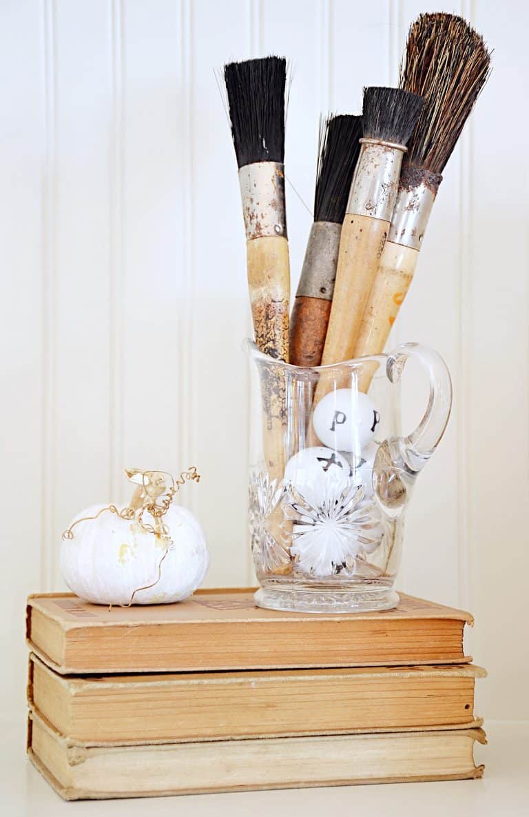 paintbrushes, pumpkin, and books