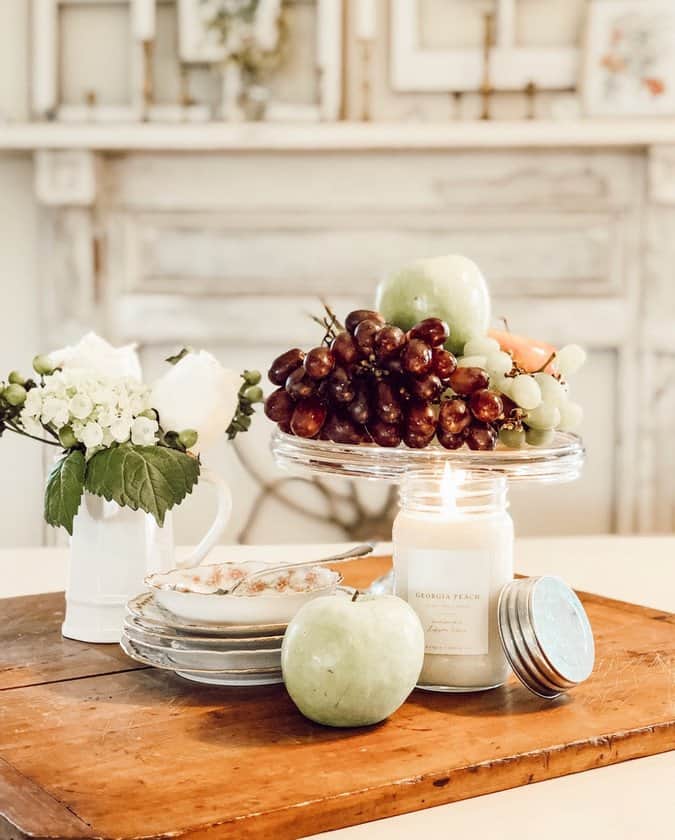 Vintage Styled Centerpiece with fruits, candles and vintage dishes.