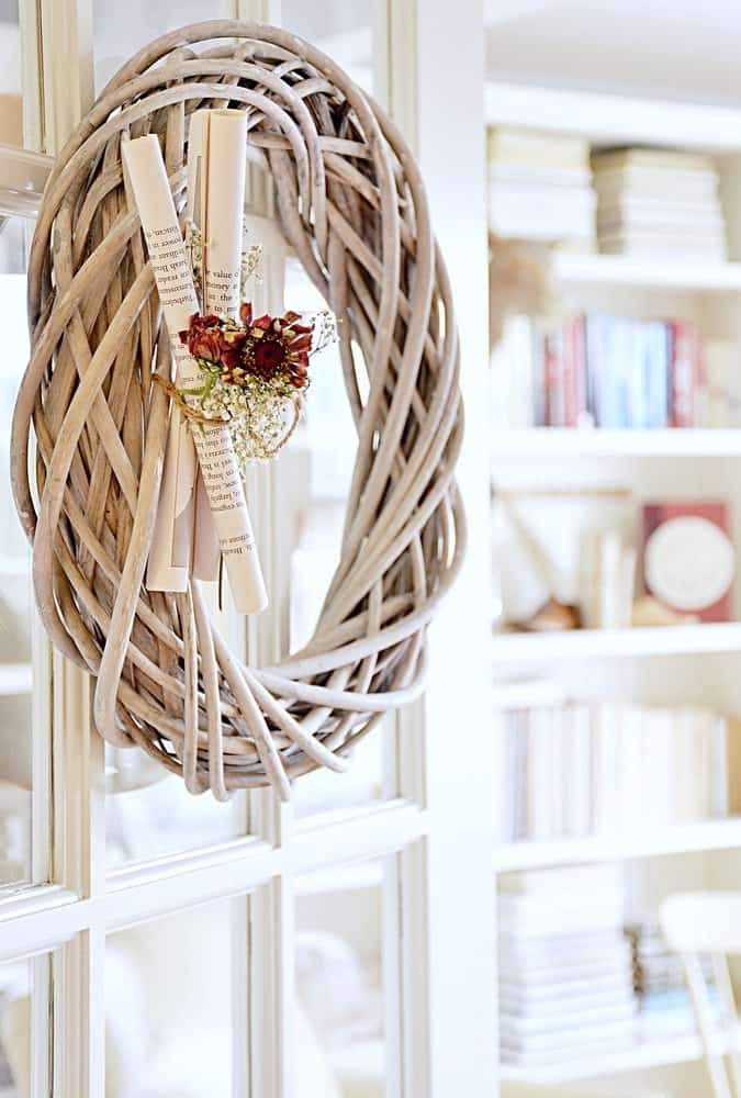 Wooden Wreath with book pages and flowers on french door.