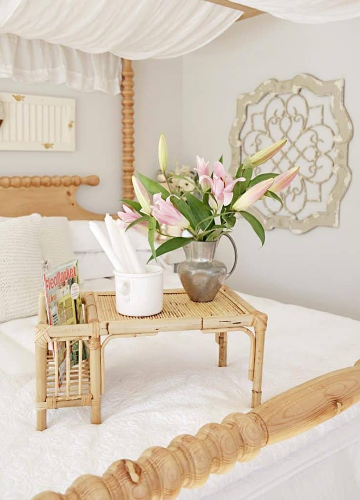 A room filled with furniture and vase of flowers on a table
