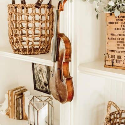 vintage style bookshelves with a violin