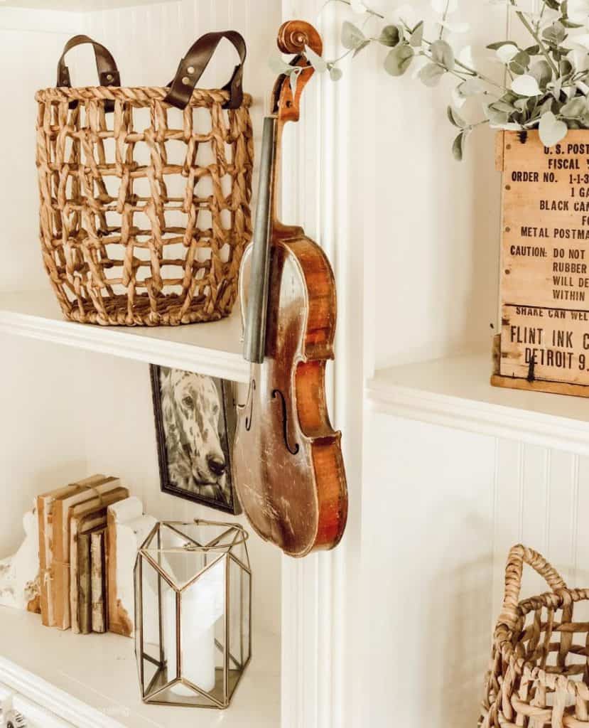 vintage style bookshelves with a violin