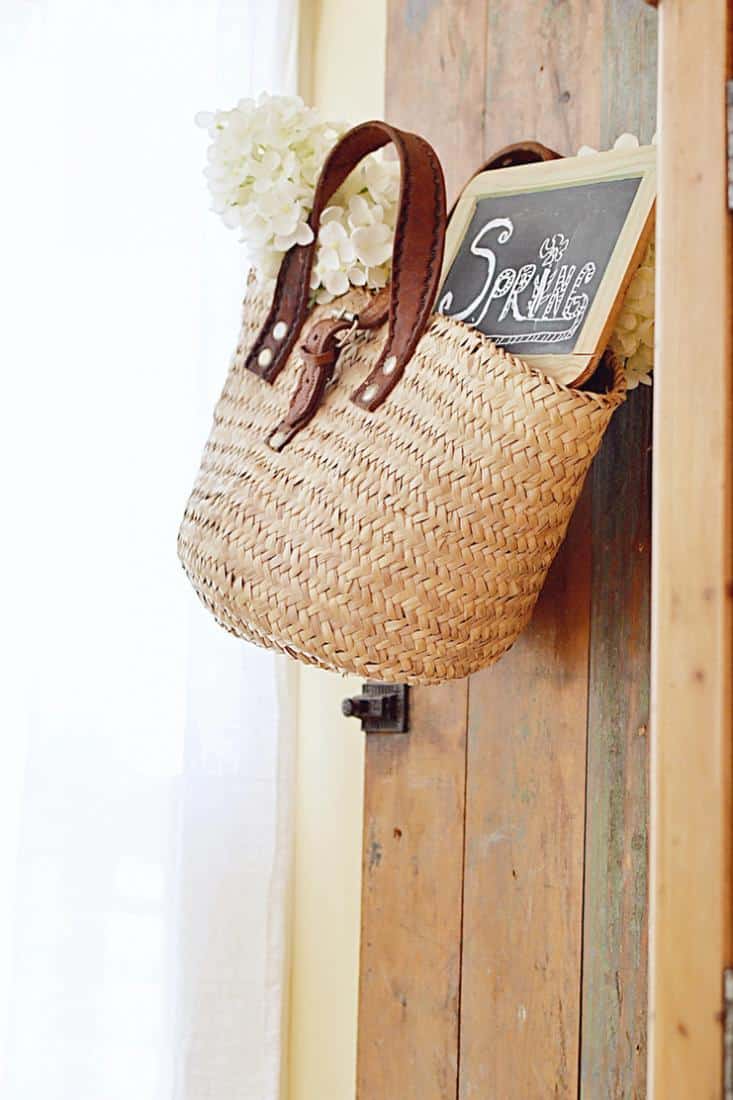 Vintage shutter with hanging basket with vintage chalkboard and white flowers for spring.