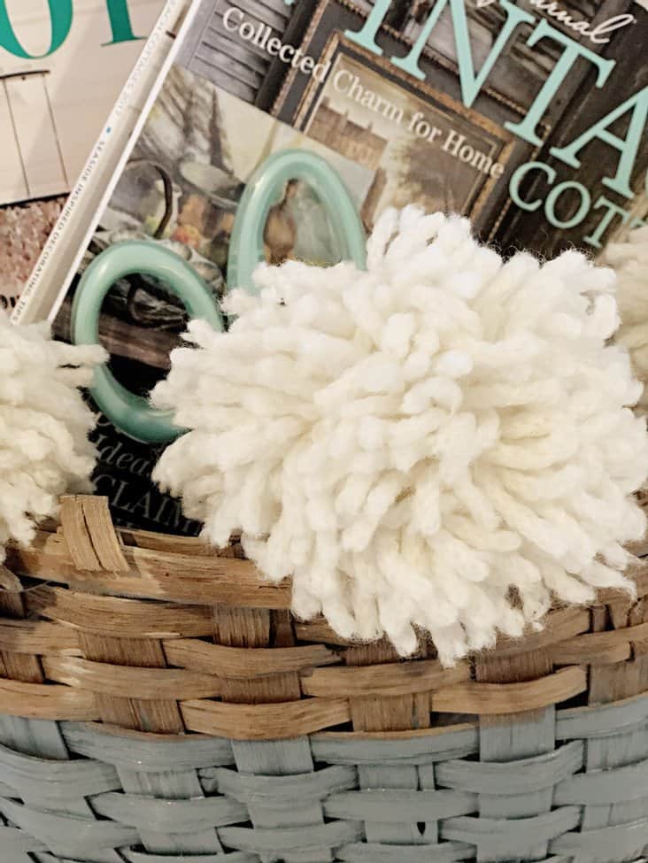 vintage basket with white pom poms
