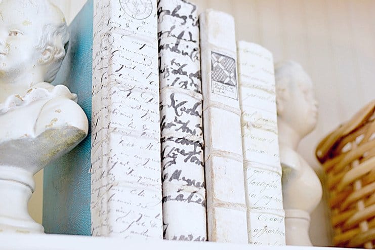 Vintage books with boy and girl bust and a neutral basket.