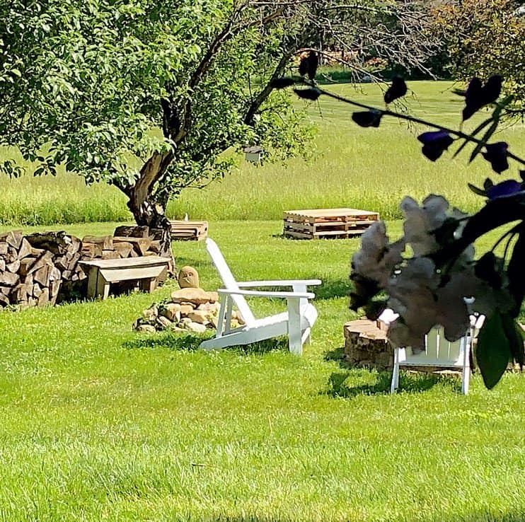 A view of the picnic space with pallets and fire pit.