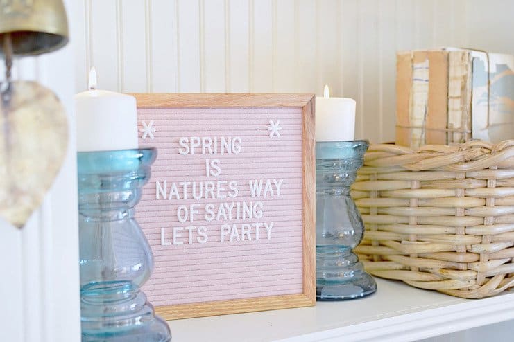 Pink felt letter board, blue candle glass candlesticks, basket, vintage books in a white built in shelving Pink felt letter board, blue candle glass candlesticks, basket, vintage books in a white built in shelving